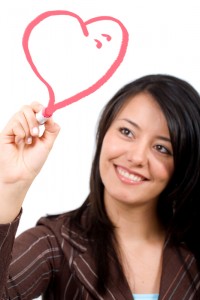 girl drawing a heart shape